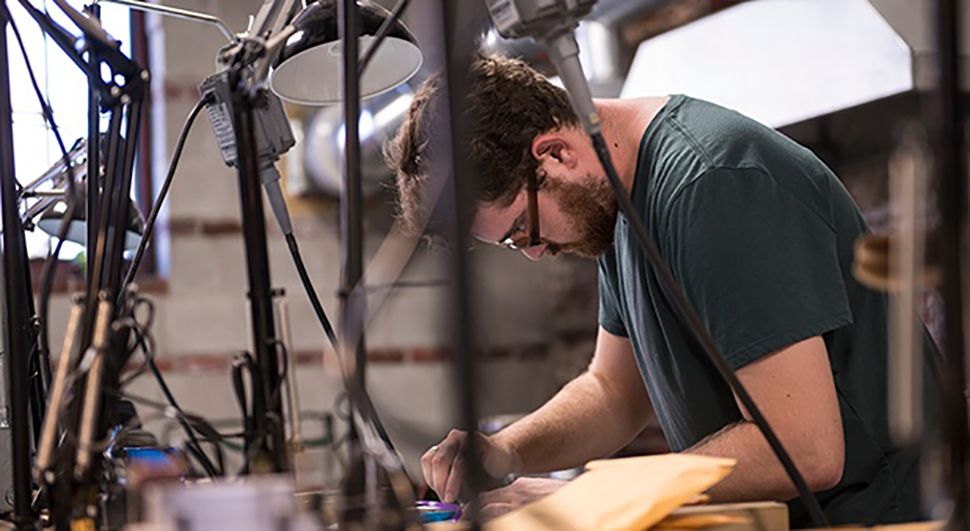 Cody Heller working on jewelry at NextFab