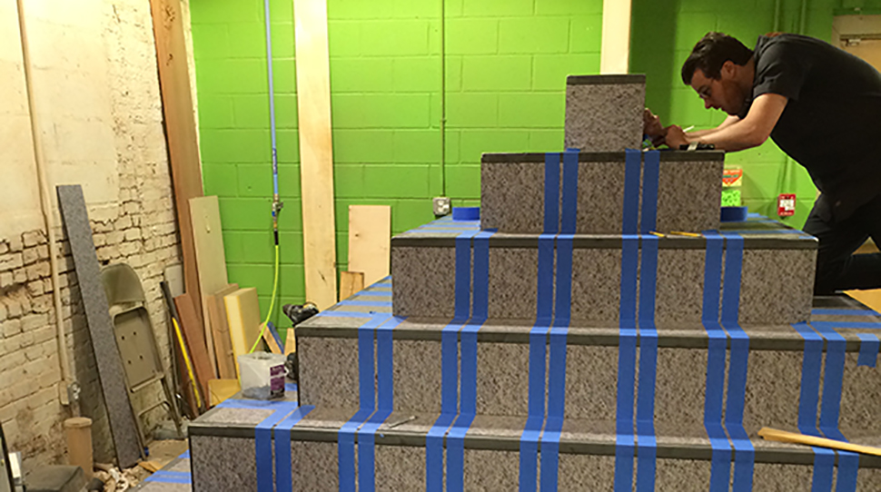 NextFab staff member assembling the pyramid at the makerspace